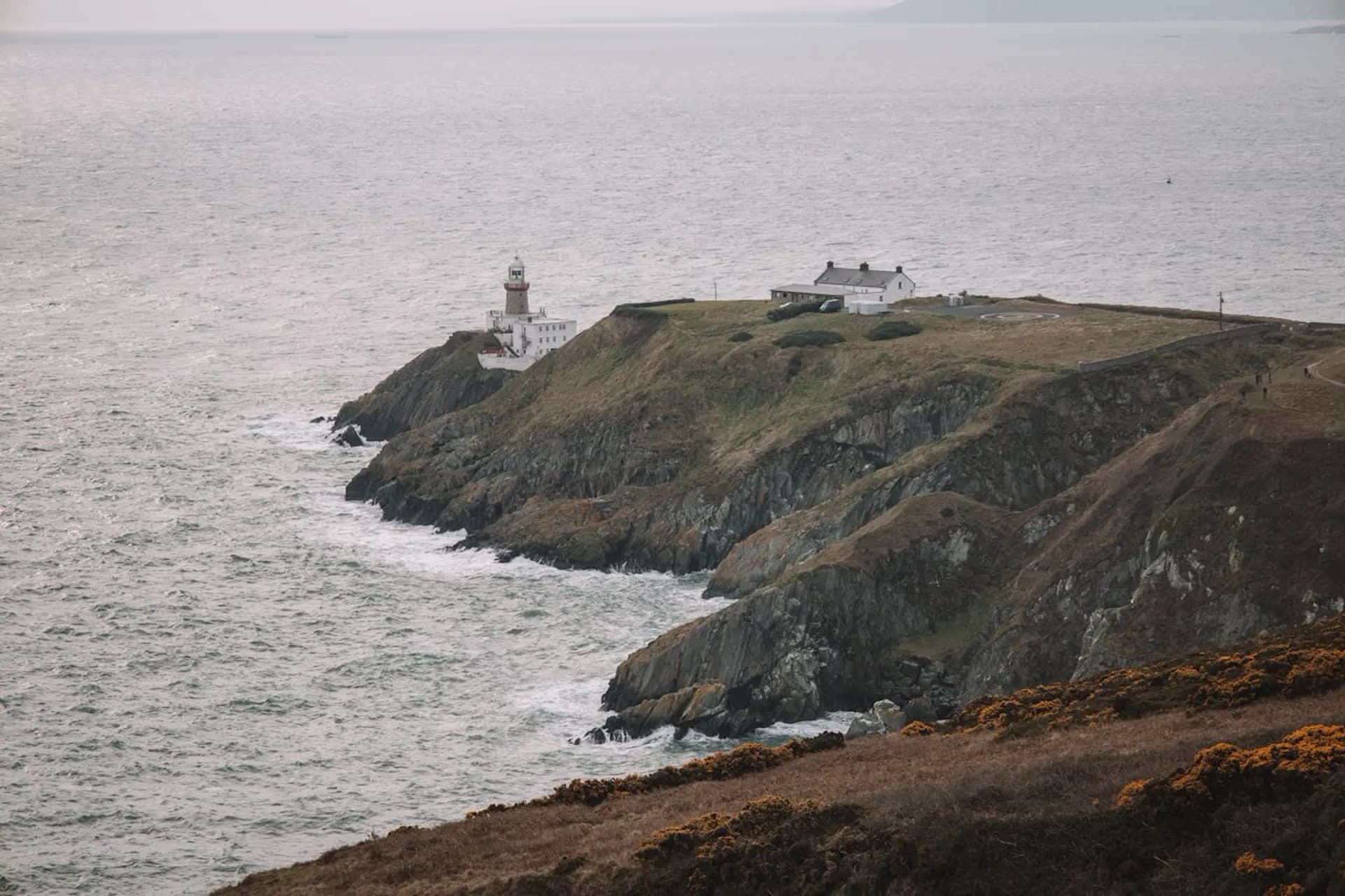 Baily Lighthouse perched on Howth Head cliffs overlooking the Irish Sea