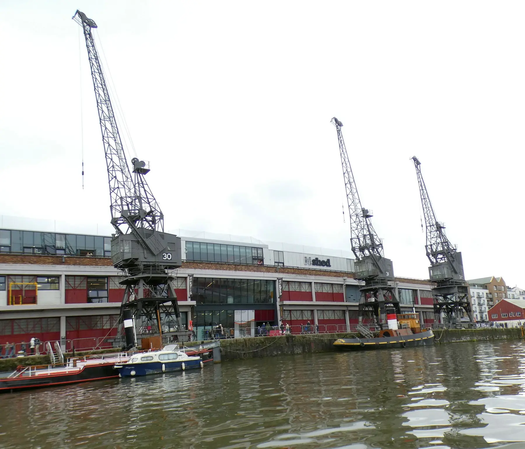 M Shed museum on Bristol's Harbourside with its three preserved dockside cranes, one still marked with its working number