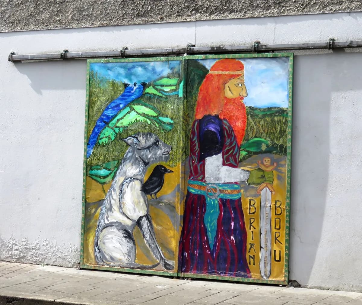 A painted Brian Boru mural in Killaloe showing the king with his sword, a wolfhound and a raven