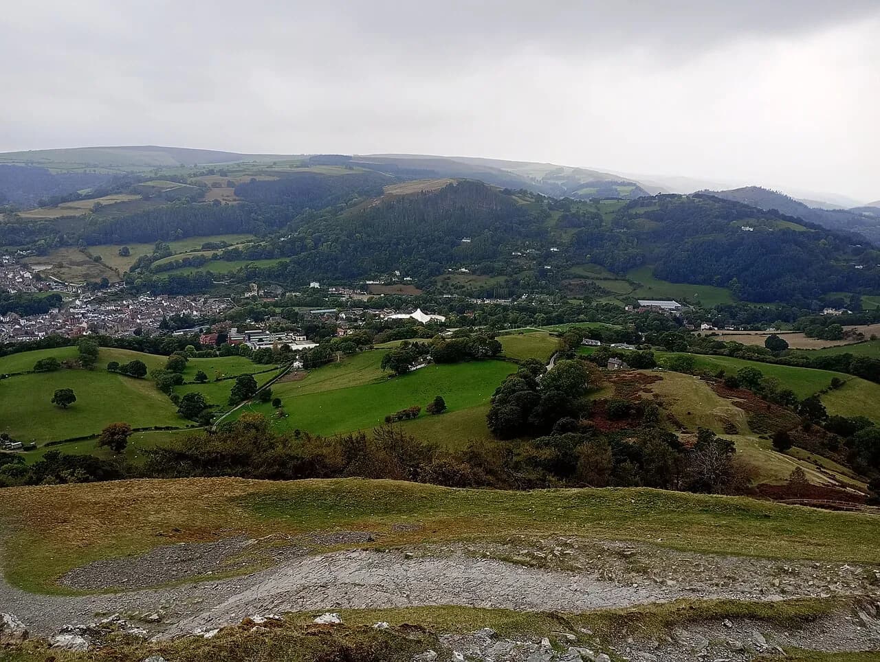 Llangollen in the Dee valley, seen from the castle hill, with the Pavilion's white roof on the edge of town