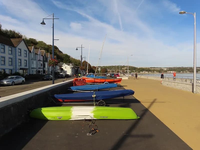 The rebuilt Mumbles promenade with dinghies on the lower deck and the seafront terraces of Mumbles Road