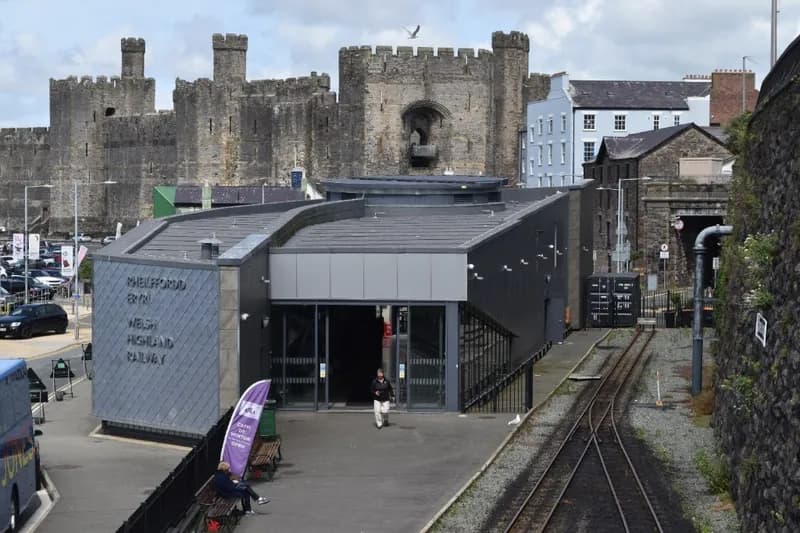 The Welsh Highland Railway station at Caernarfon with the castle behind