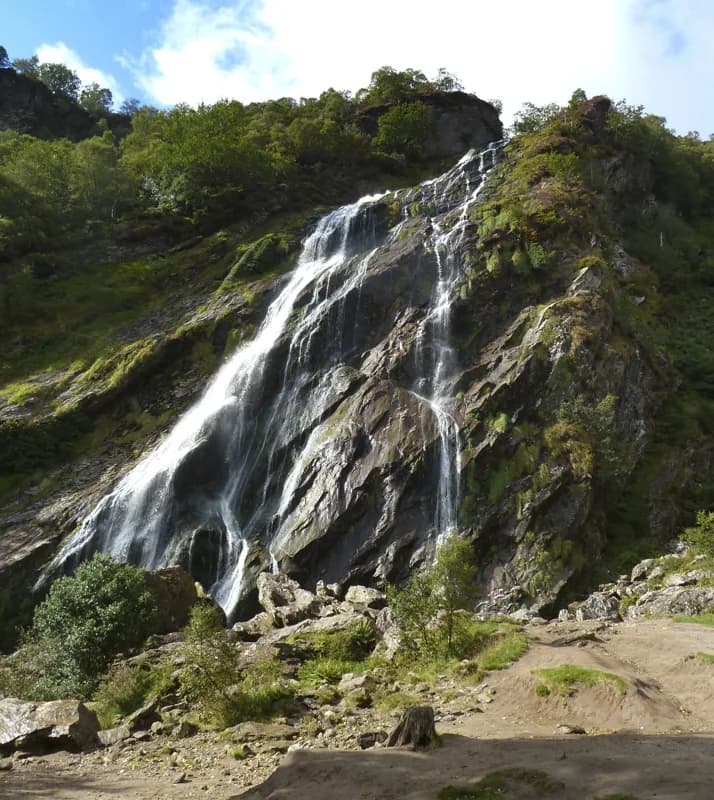 Powerscourt Waterfall dropping down its rock face into the parkland below