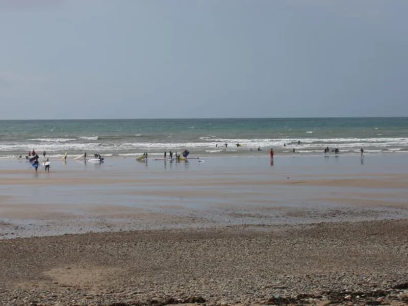 Surfers and beginners in the water off Tramore strand